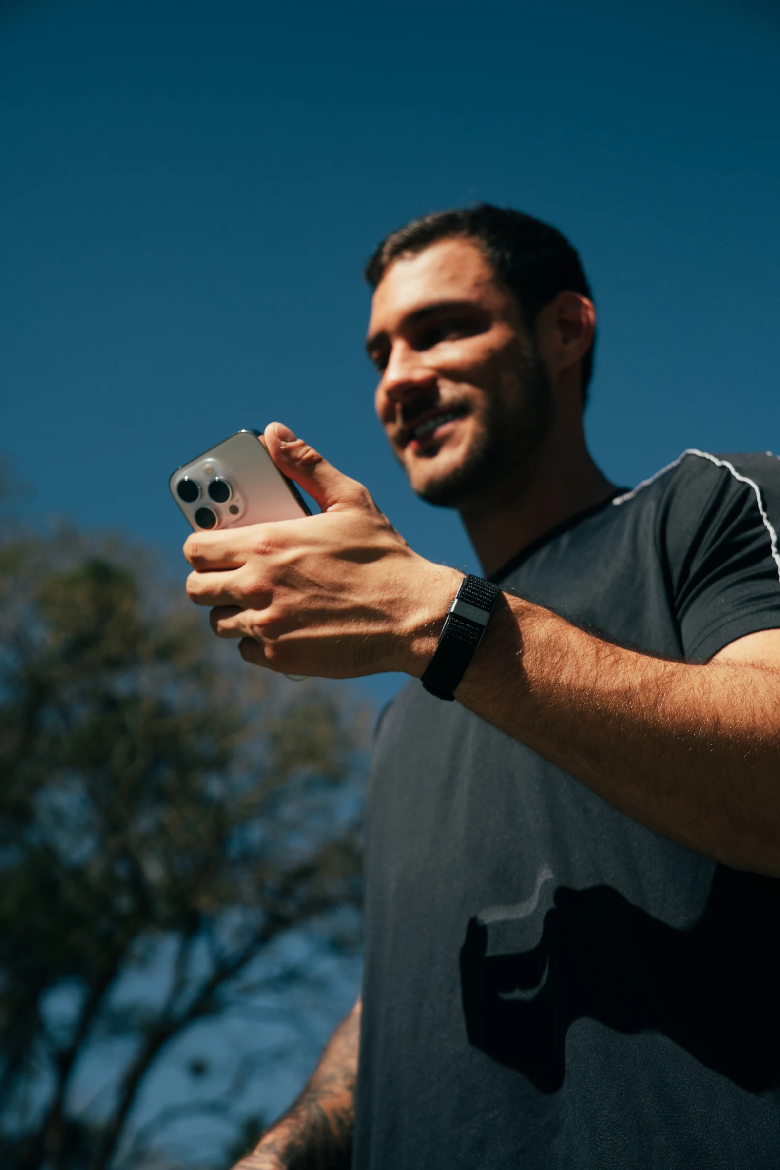 Man wearing the band while checking his phone outdoors